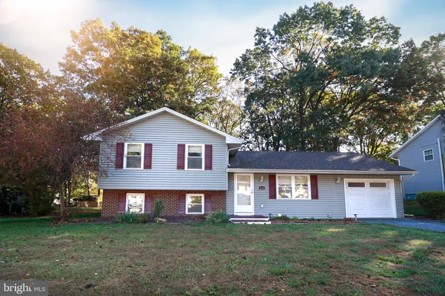 a front view of a house with a garden and yard