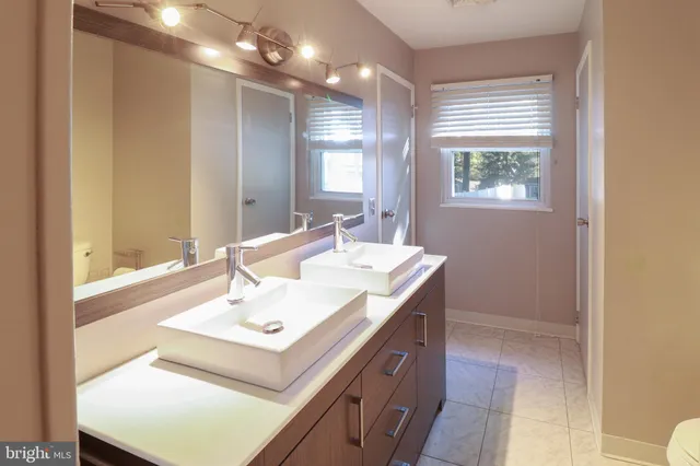 a bathroom with a sink vanity and a mirror