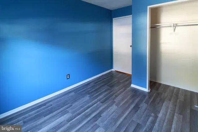 a view of a room with wooden floor