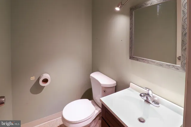 a white toilet sitting next to a bathroom sink