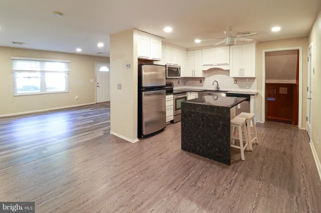 a kitchen with refrigerator and cabinets