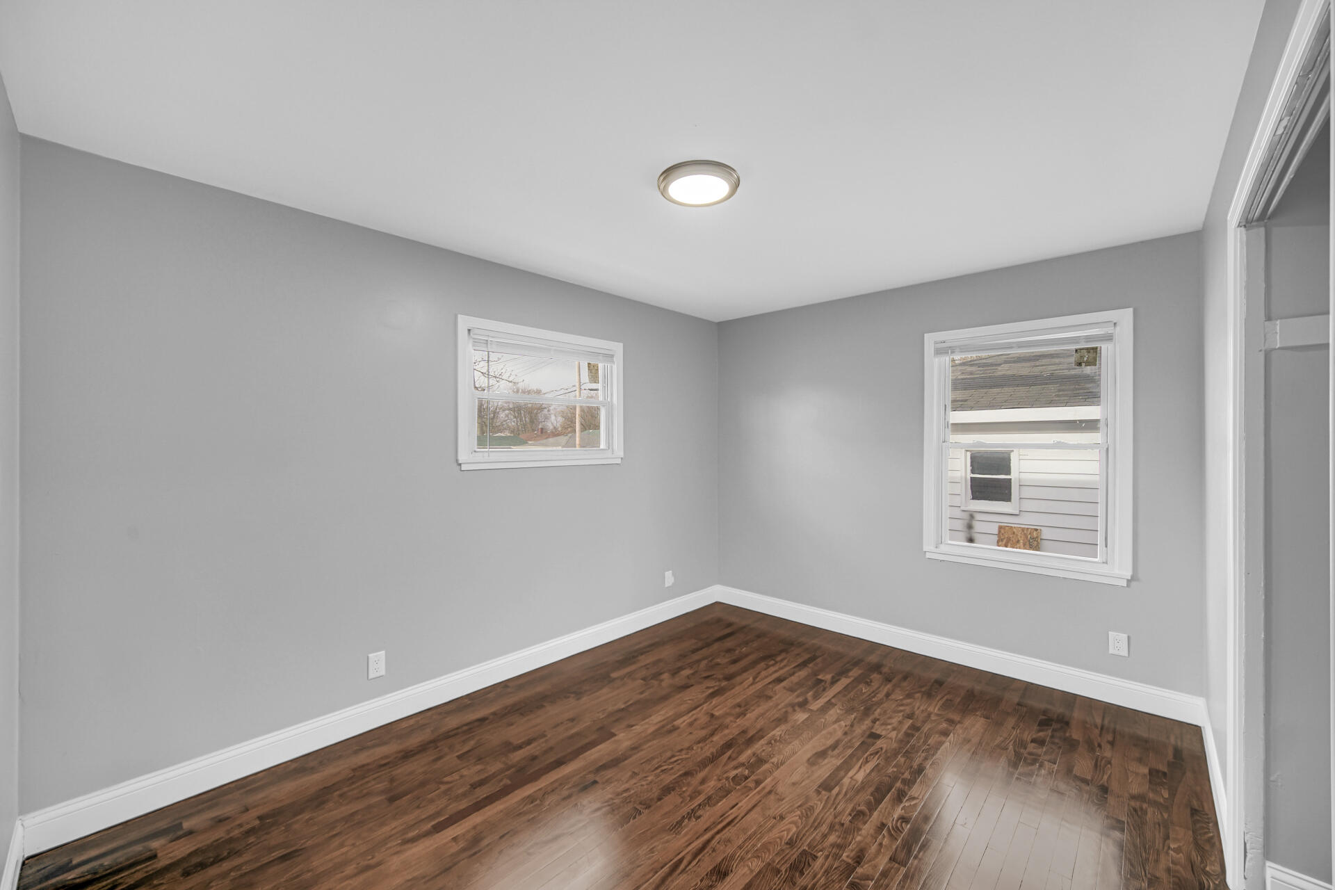 699 State Street Gary, IN 46403 - Photo 11 of 24 a view of a big room with wooden floor and windows