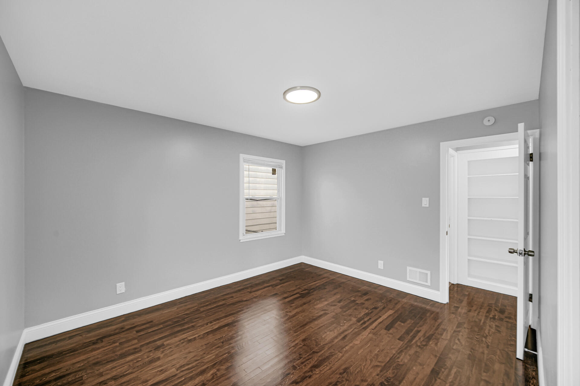 699 State Street Gary, IN 46403 - Photo 14 of 24 a view of an empty room with wooden floor and a window