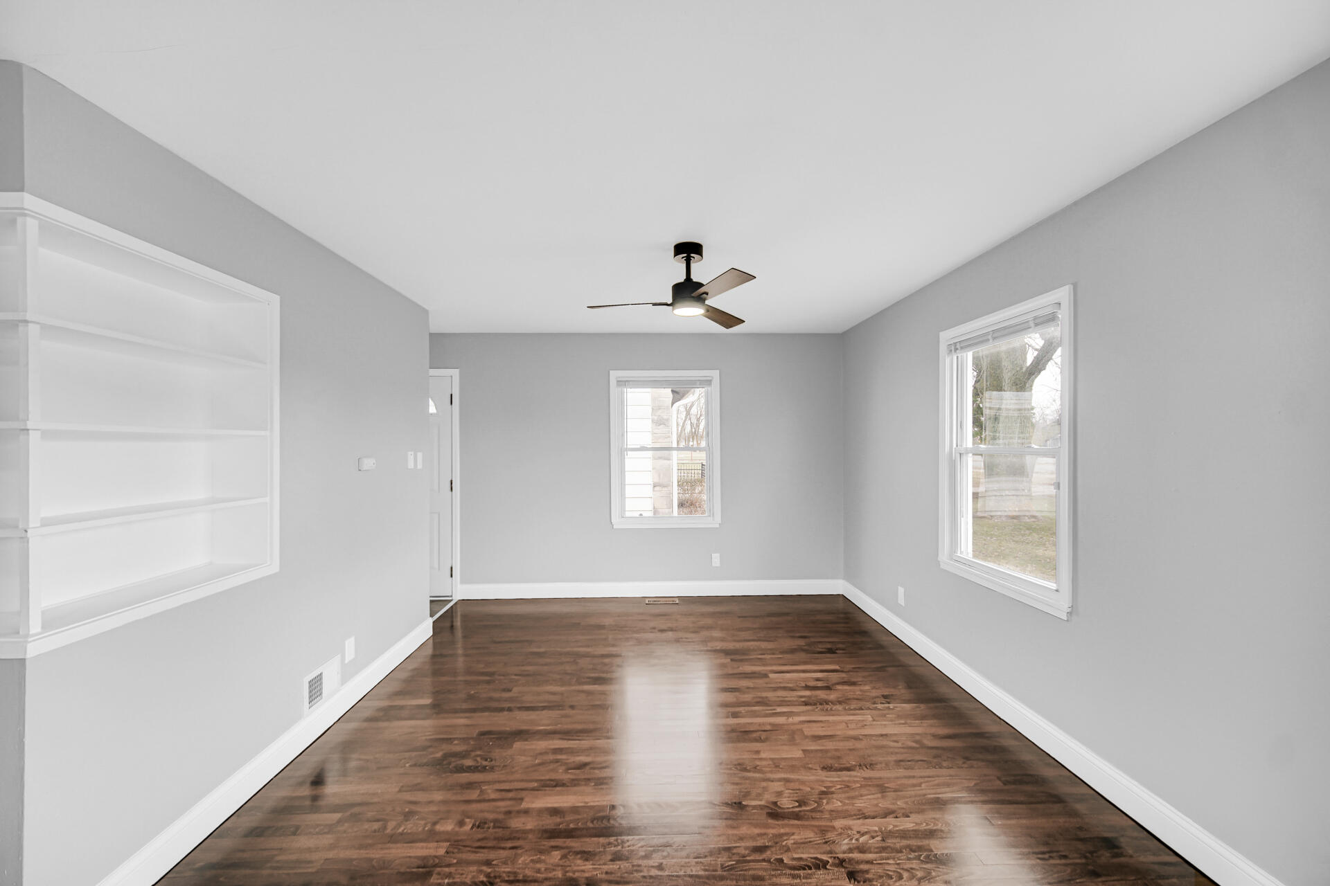 699 State Street Gary, IN 46403 - Photo 5 of 24 a view of an empty room with wooden floor and a window