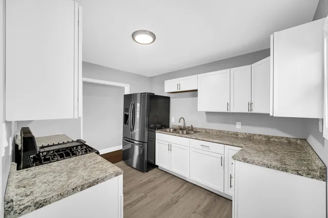 a kitchen with a sink stove and refrigerator