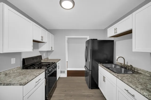 a kitchen with stainless steel appliances granite countertop a sink stove and refrigerator