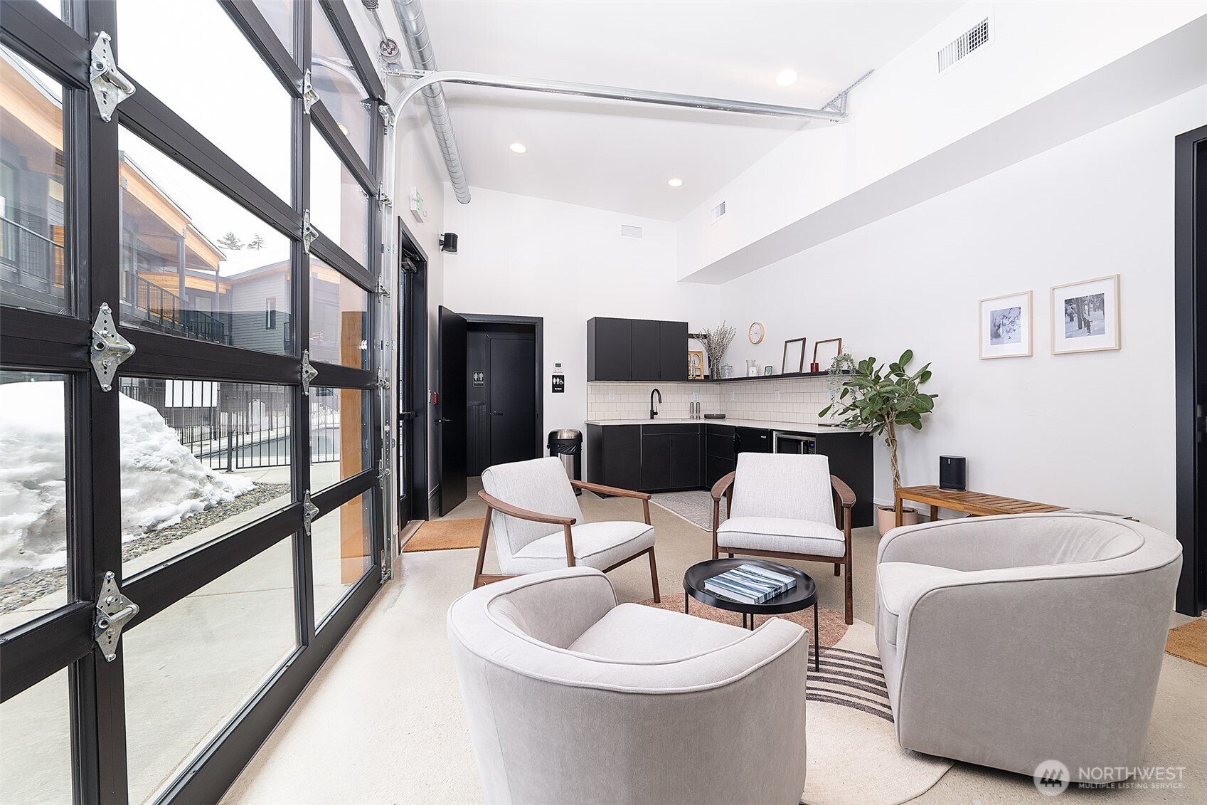 200 Pass Life Way, Unit 1 Snoqualmie Pass, WA 98068 - Photo 19 of 27 a dining room with furniture and a floor to ceiling window