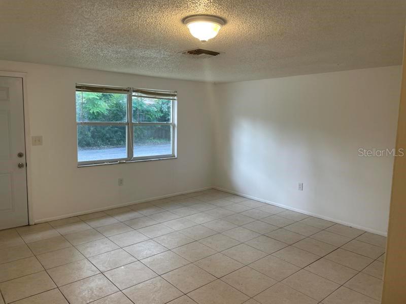 6939 McBride Court New Port Richey, FL 34652 - Photo 2 of 9 an empty room with windows