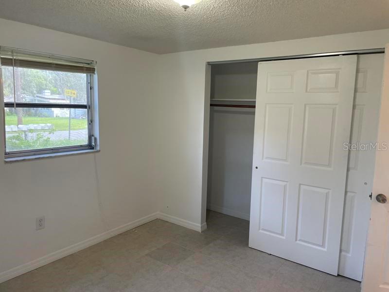 6939 McBride Court New Port Richey, FL 34652 - Photo 8 of 9 an empty room with a empty space and window