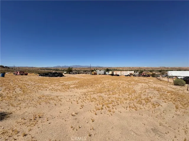 a view of a dry yard with a snow on the road