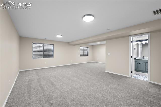 5428 Rondo Way Colorado Springs, CO 80911 - Photo 32 of 43 Below grade area featuring light carpet and healthy amount of natural light