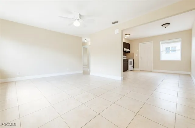 a view of a livingroom with an empty space and a ceiling fan