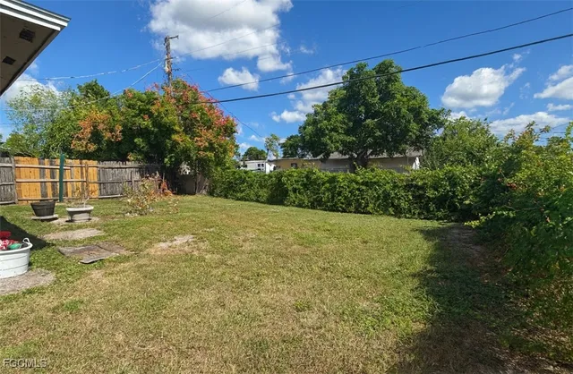 a backyard of a house with table and chairs