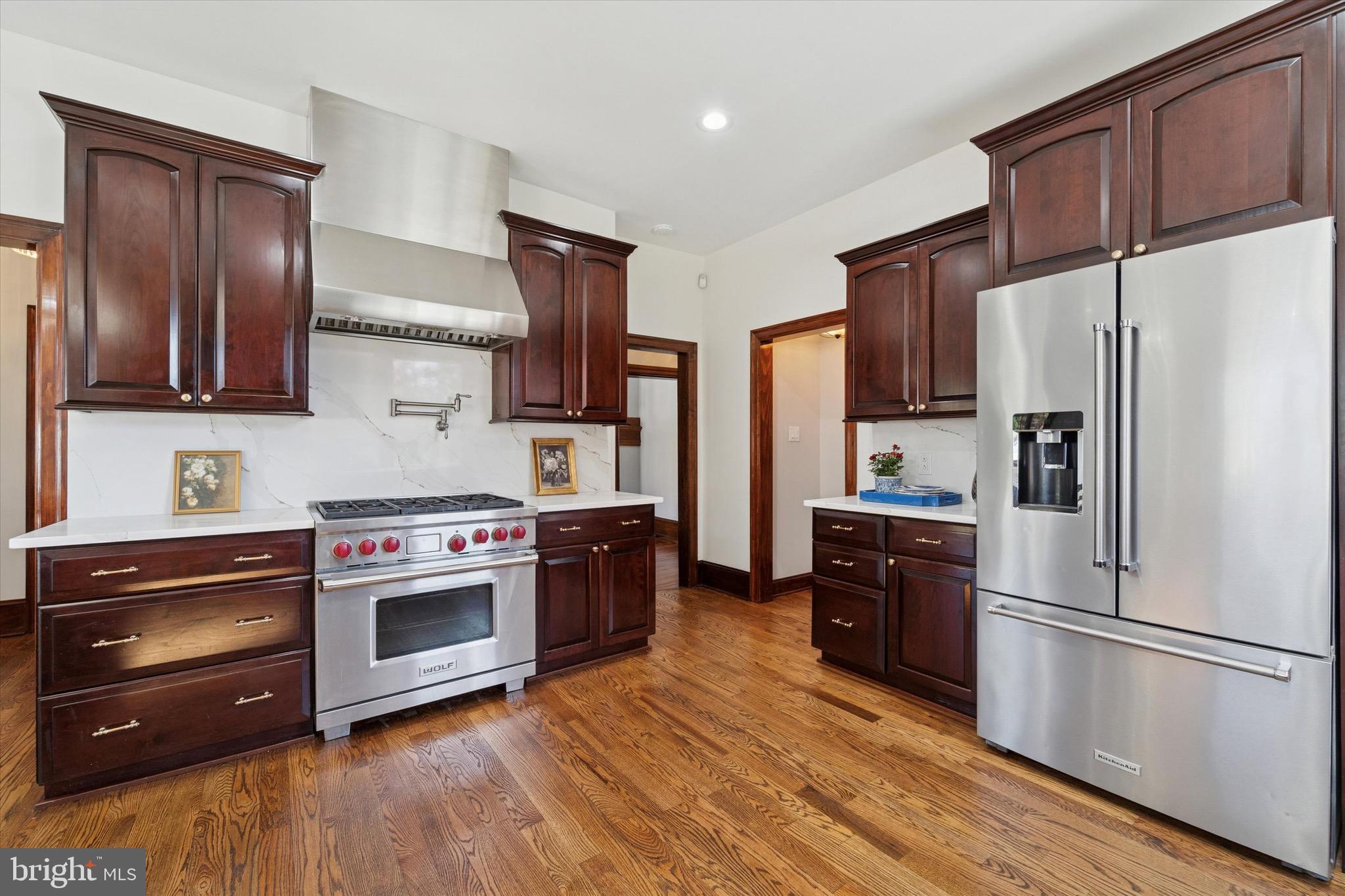 204 East Manoa Road Havertown, PA 19083 - Photo 19 of 80 a kitchen with stainless steel appliances wooden cabinets sink and wooden floor