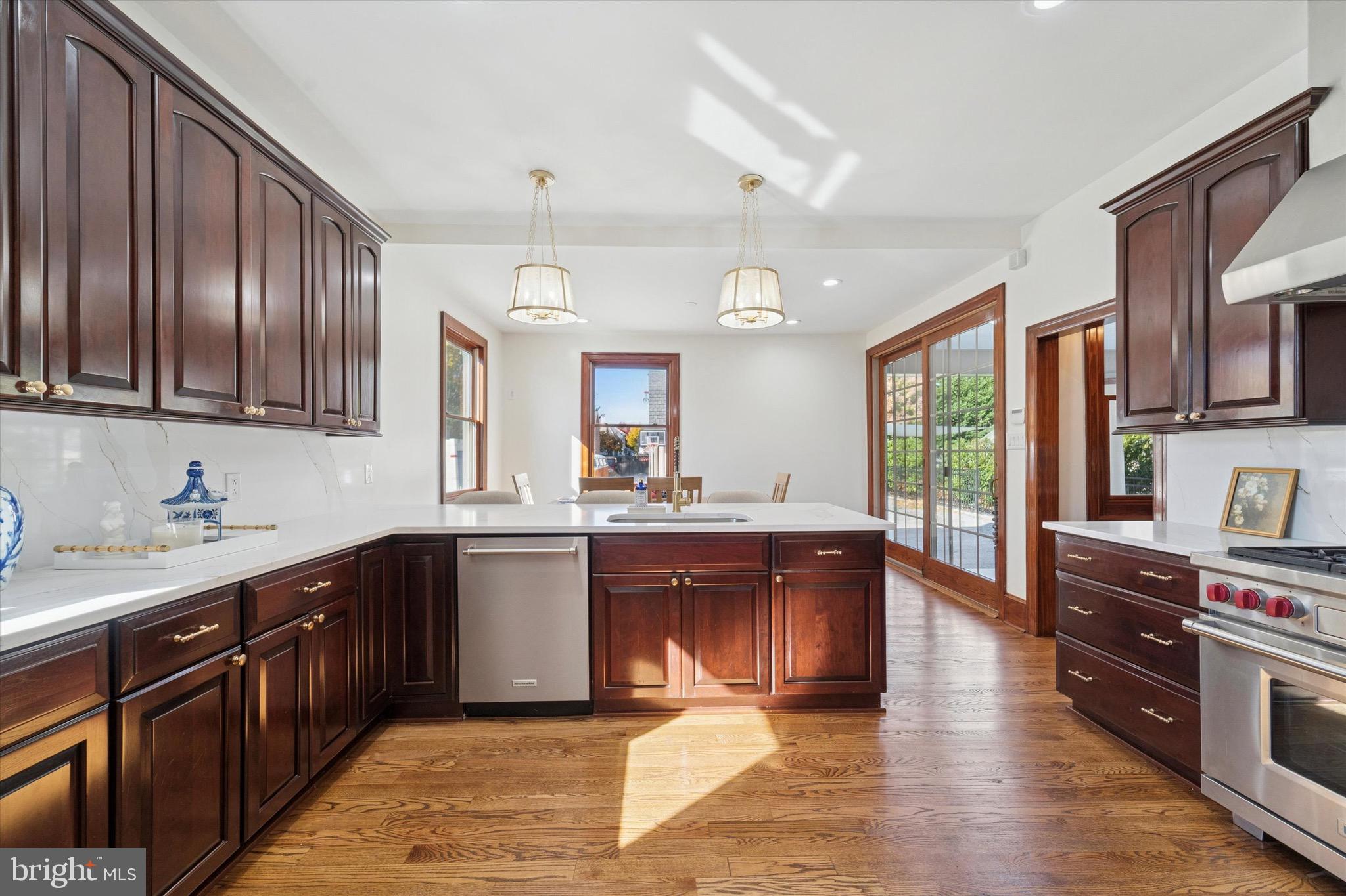 204 East Manoa Road Havertown, PA 19083 - Photo 24 of 80 a kitchen with stainless steel appliances granite countertop wooden cabinets a sink dishwasher and a stove with wooden floor