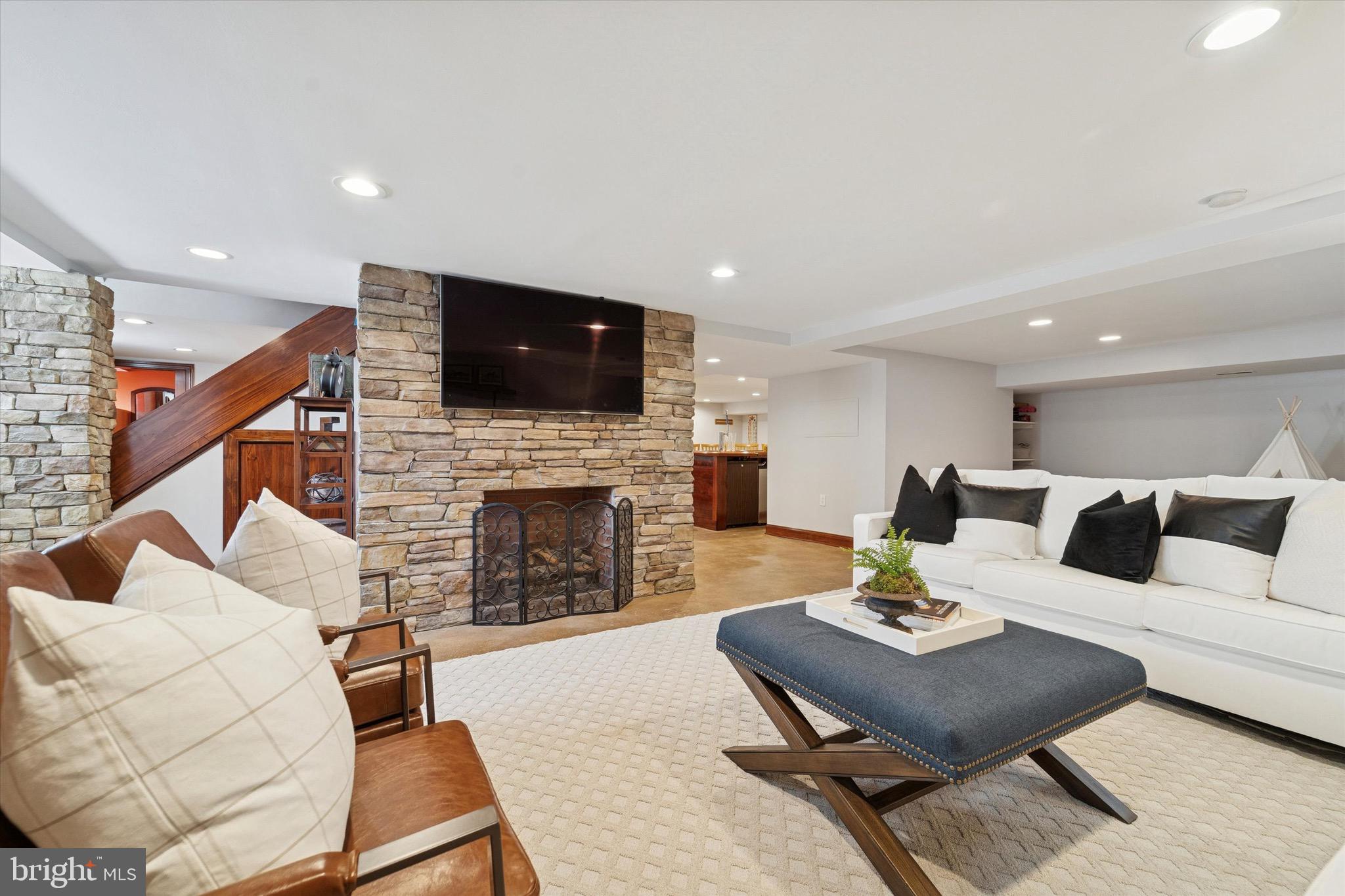 204 East Manoa Road Havertown, PA 19083 - Photo 28 of 80 a living room with furniture a fireplace and flat screen tv