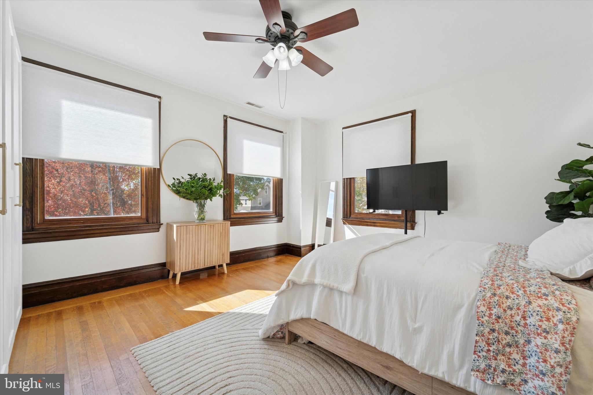 204 East Manoa Road Havertown, PA 19083 - Photo 33 of 80 a bedroom with a bed flat screen tv and a large window