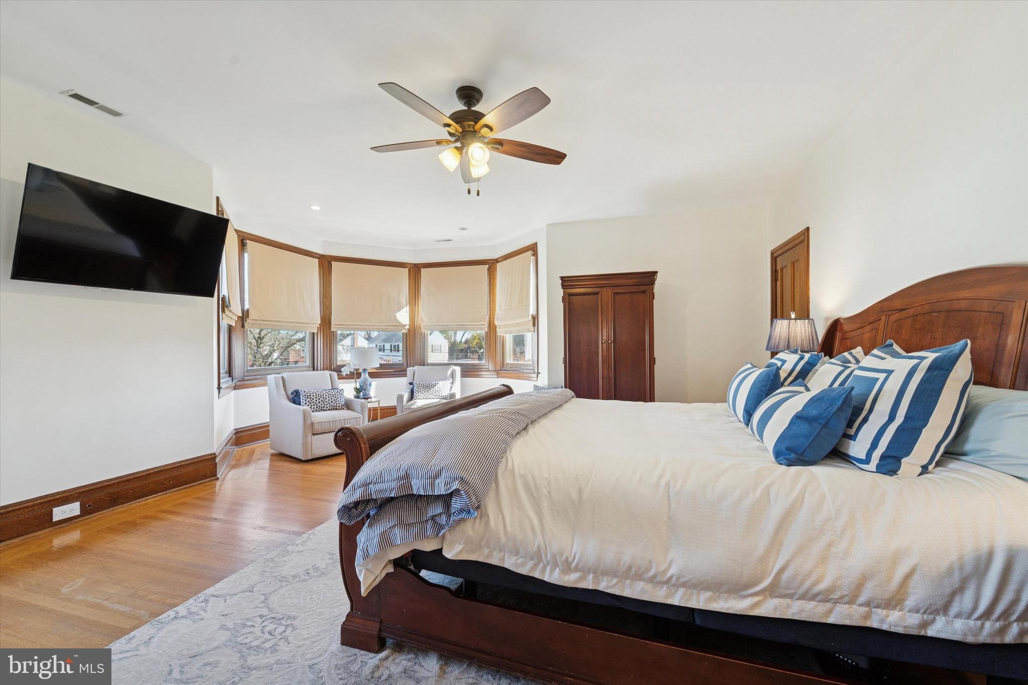 204 East Manoa Road Havertown, PA 19083 - Photo 38 of 80 a bedroom with a large bed and a chandelier