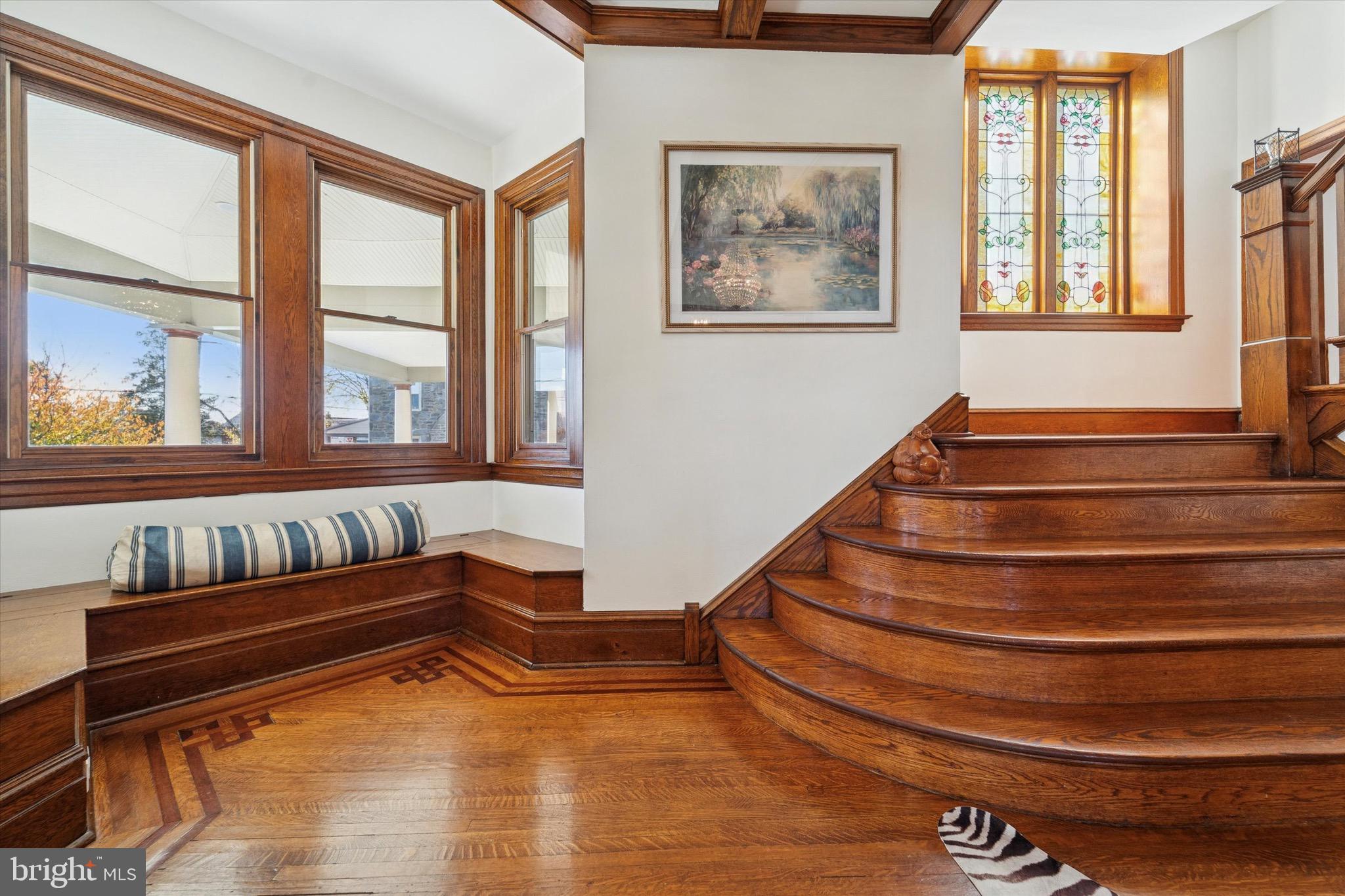 204 East Manoa Road Havertown, PA 19083 - Photo 5 of 80 a view of staircase with lots of frames on wall and a window