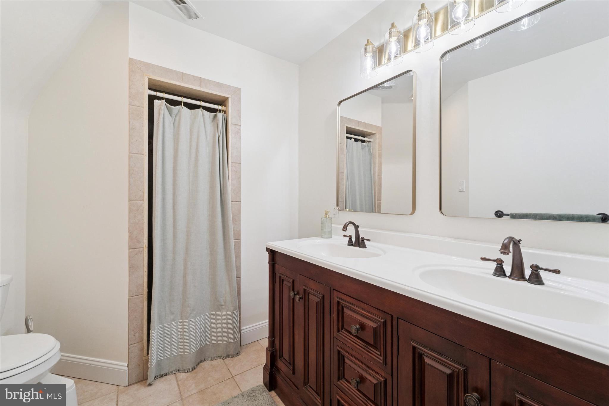 204 East Manoa Road Havertown, PA 19083 - Photo 51 of 80 a bathroom with a double vanity sink and mirror