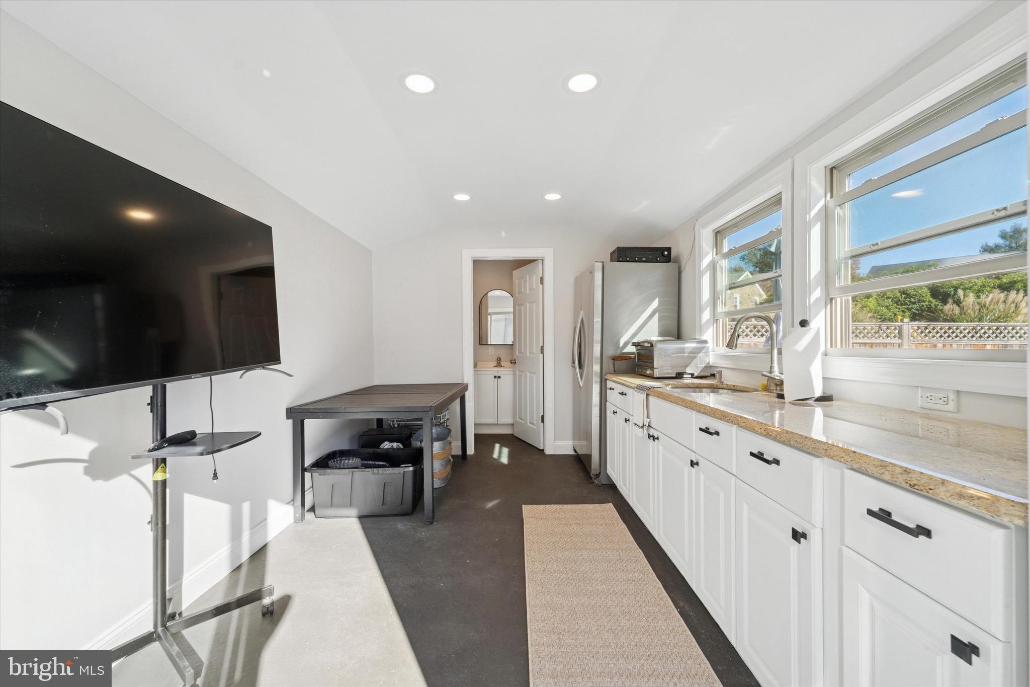 204 East Manoa Road Havertown, PA 19083 - Photo 70 of 80 a large living room with stainless steel appliances furniture and a flat screen tv