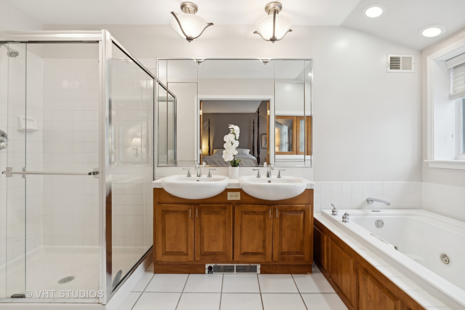 803 Hibbard Road Wilmette, IL 60091 - Photo 13 of 23 a bathroom with a sink a faucet a mirror and a bathtub