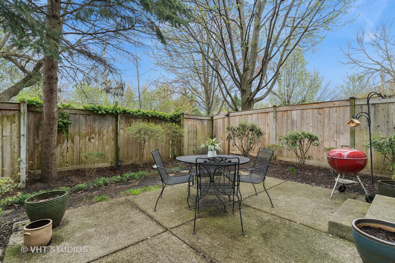 803 Hibbard Road Wilmette, IL 60091 - Photo 18 of 23 a view of a patio with table and chairs potted plants and large tree