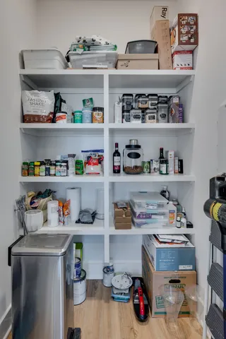 a room with a wooden floor and shelf
