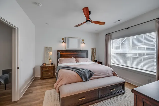 a bedroom with a bed and a window