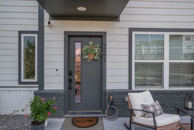 a front view of a house with a potted plant