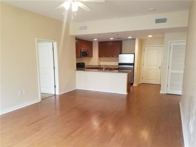 1200 Main Street, Unit 1010 Dallas, TX 75202 - Photo 1 of 13 a view of a kitchen with a sink and a refrigerator