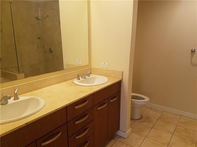 1200 Main Street, Unit 1010 Dallas, TX 75202 - Photo 8 of 13 a bathroom with a sink and a mirror