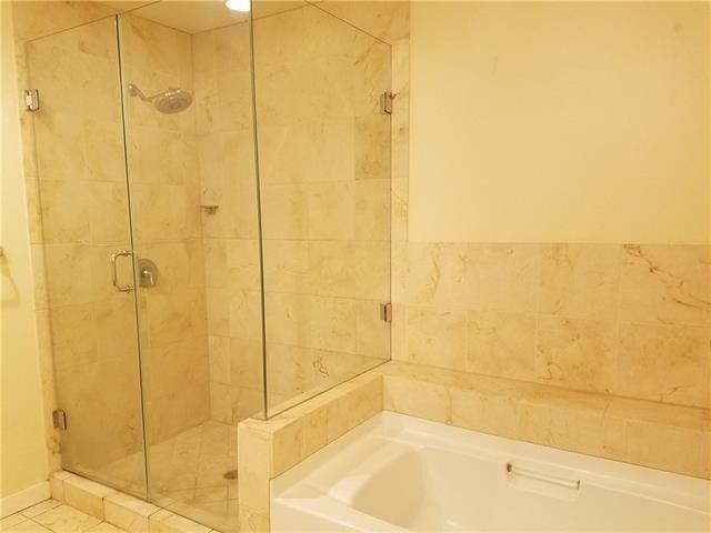 1200 Main Street, Unit 1010 Dallas, TX 75202 - Photo 9 of 13 a bathroom with a bathtub