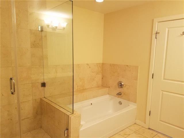 1200 Main Street, Unit 1010 Dallas, TX 75202 - Photo 10 of 13 a bathroom with a tub shower and sink