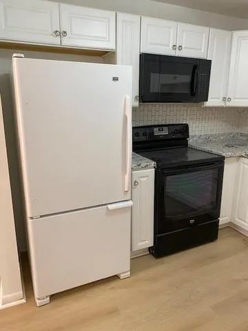 a kitchen with appliances and cabinets