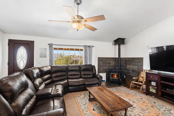 a spacious bedroom with a bed and a flat screen tv