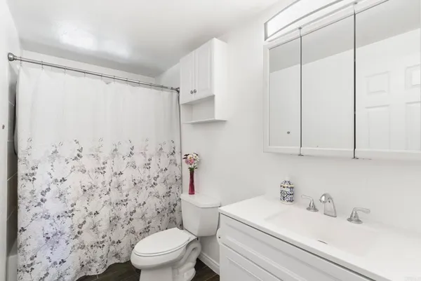 a bedroom with a bed and a ceiling fan