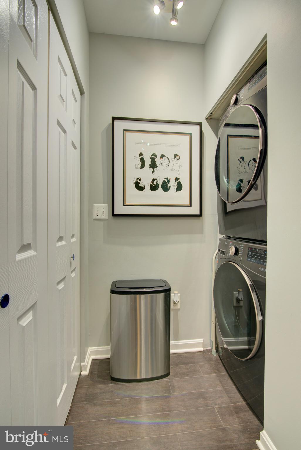 1855 Stratford Park Place, Unit 310 Reston, VA 20190 - Photo 12 of 62 a view of a hallway with washer and dryer