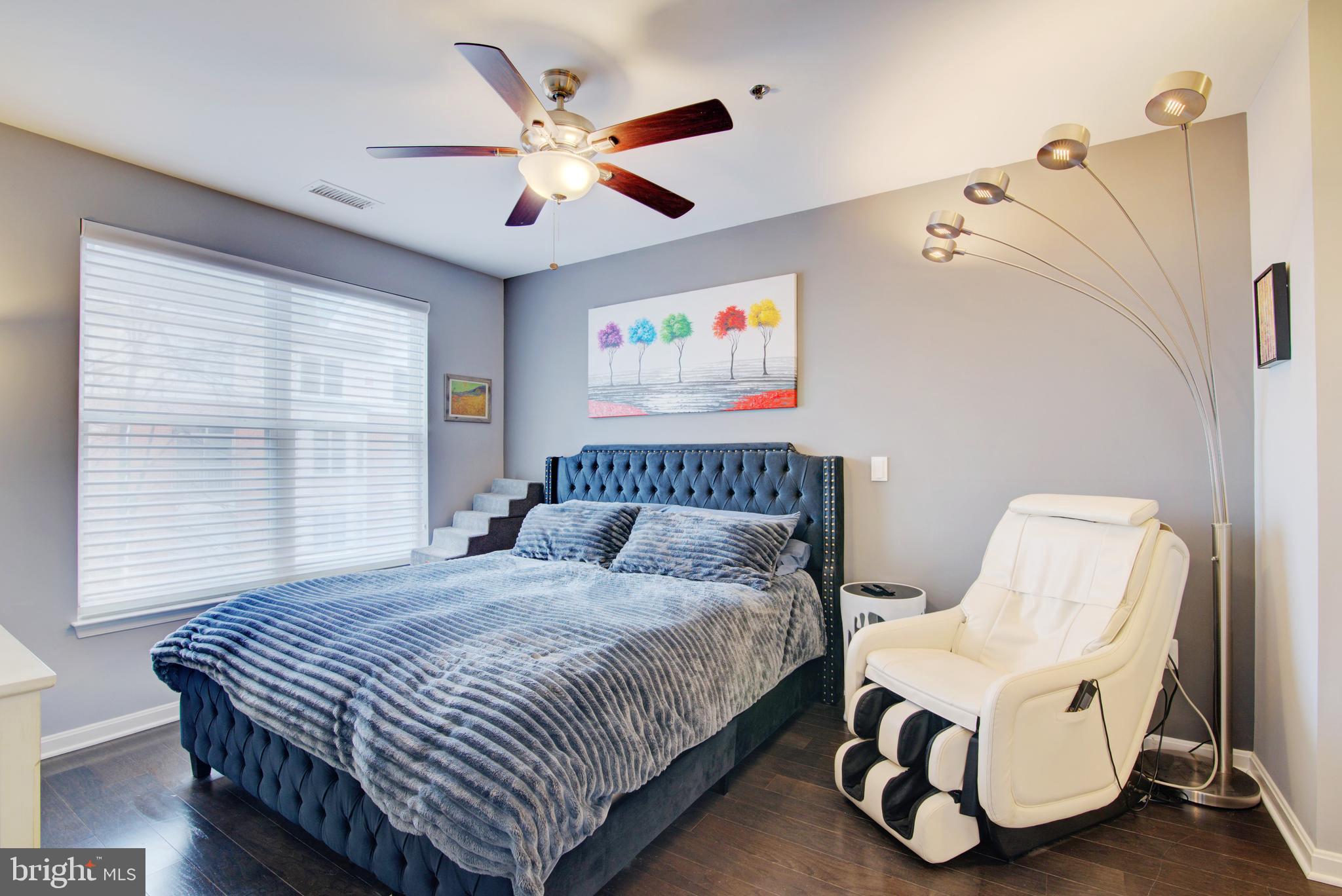 1855 Stratford Park Place, Unit 310 Reston, VA 20190 - Photo 13 of 62 a bedroom with a bed and a chair
