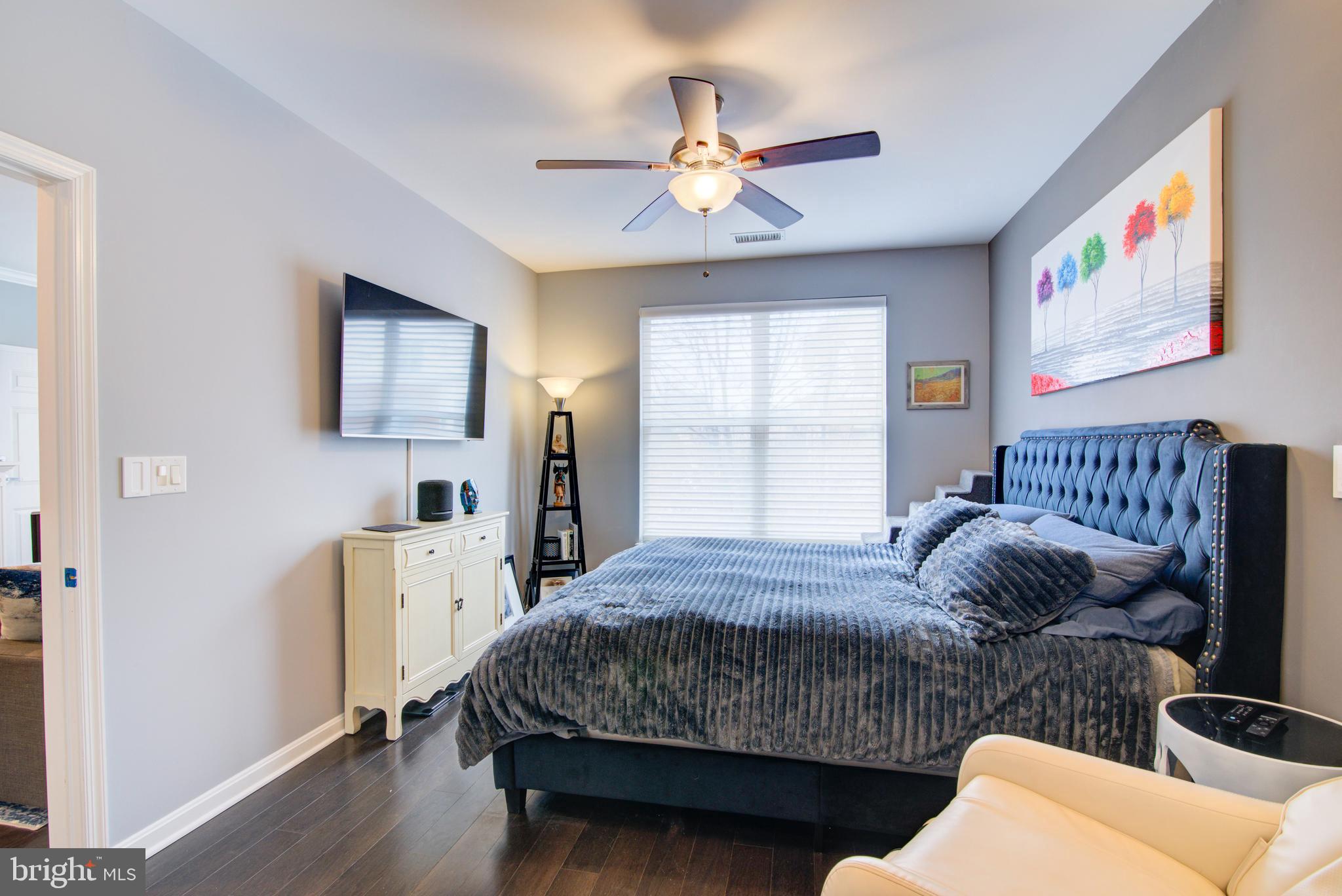 1855 Stratford Park Place, Unit 310 Reston, VA 20190 - Photo 14 of 62 a bedroom with a bed and a chandelier