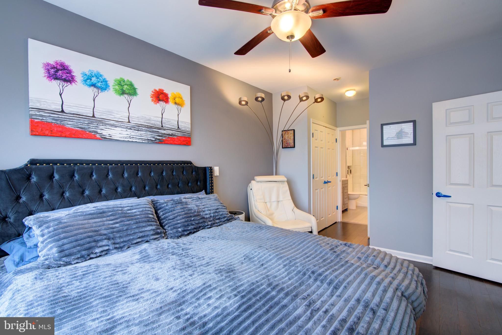 1855 Stratford Park Place, Unit 310 Reston, VA 20190 - Photo 15 of 62 a bedroom with a bed and wooden floor