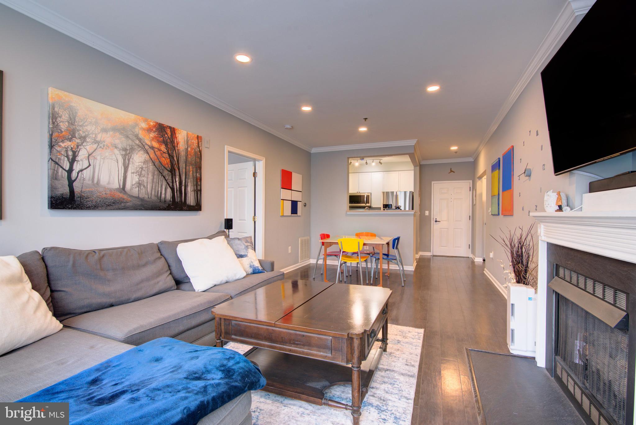 1855 Stratford Park Place, Unit 310 Reston, VA 20190 - Photo 61 of 62 a living room with furniture and a flat screen tv