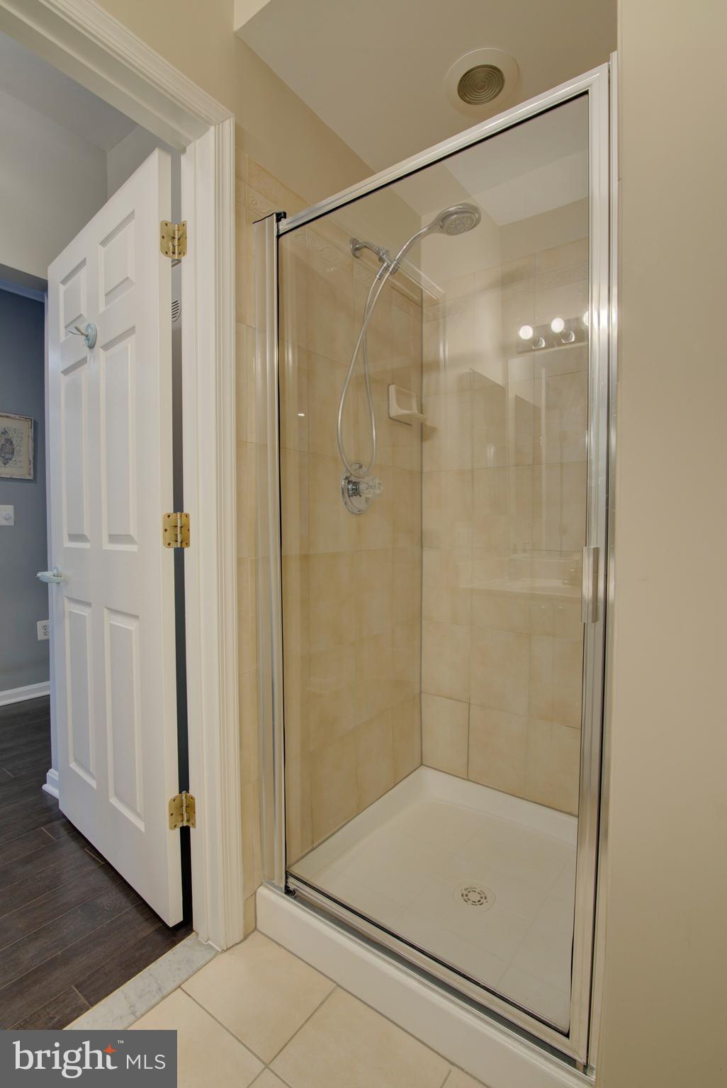 1855 Stratford Park Place, Unit 310 Reston, VA 20190 - Photo 23 of 62 a bathroom with a glass shower door