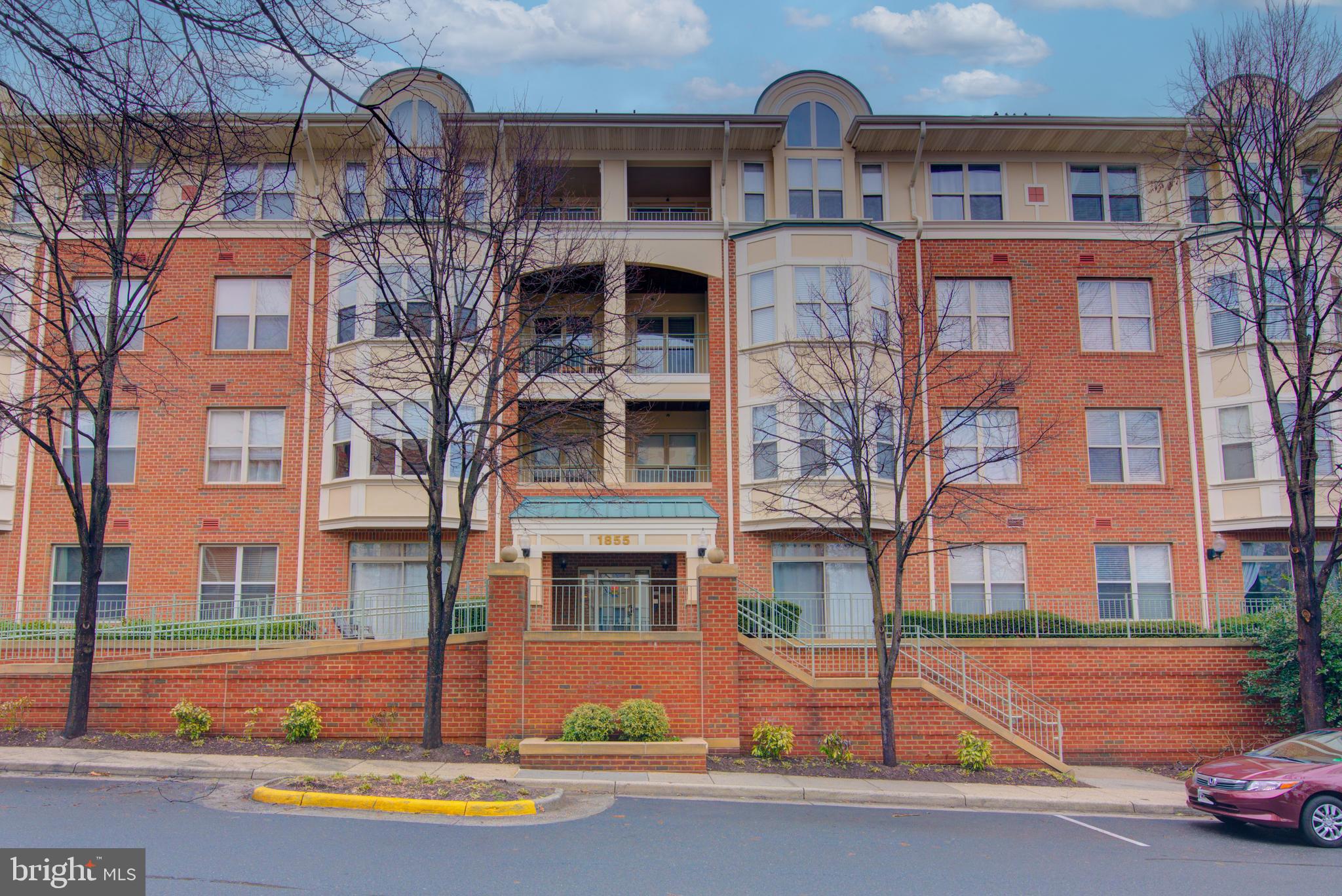 1855 Stratford Park Place, Unit 310 Reston, VA 20190 - Photo 27 of 62 a front view of a building with street view