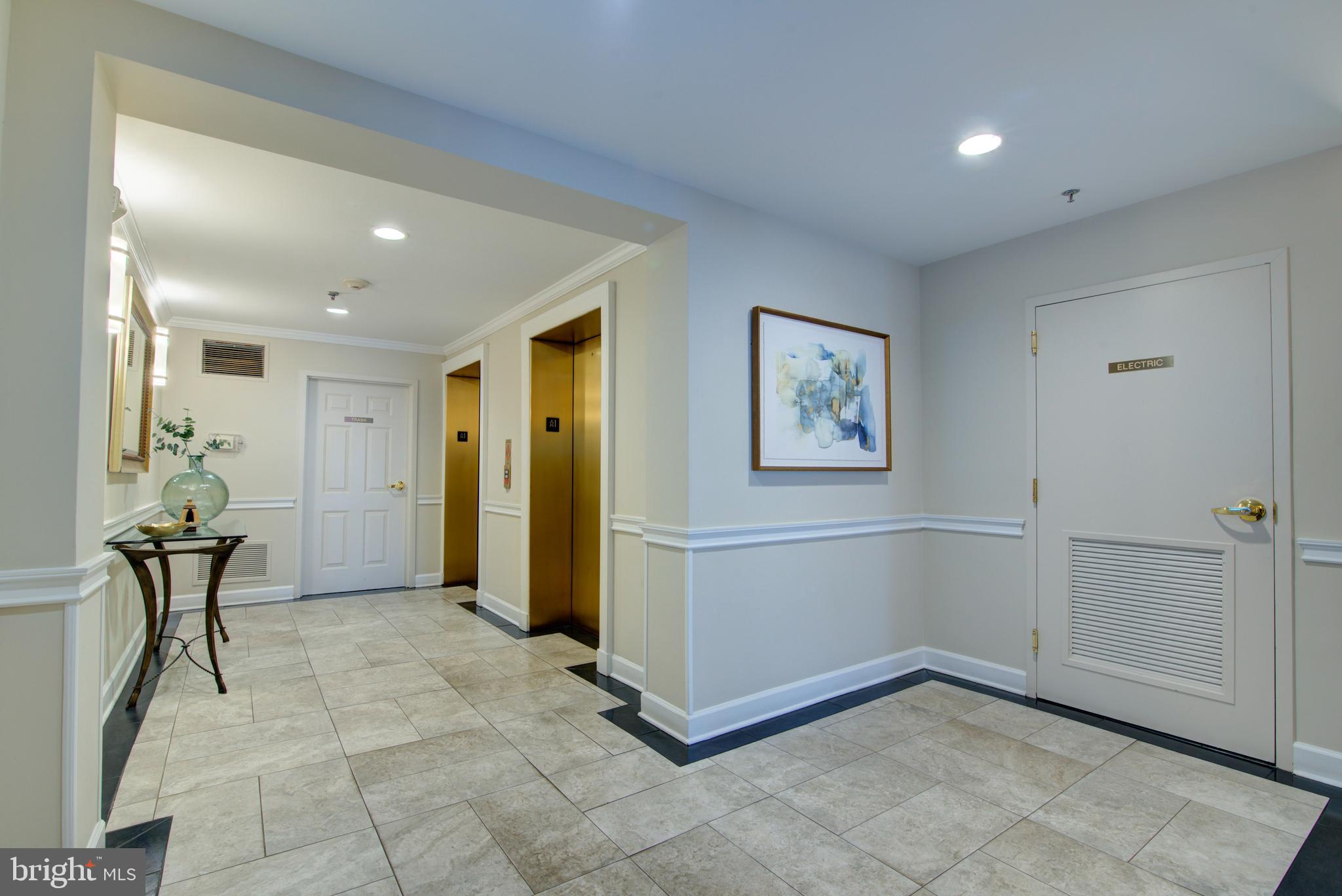1855 Stratford Park Place, Unit 310 Reston, VA 20190 - Photo 34 of 62 a view of a hallway with a elevator