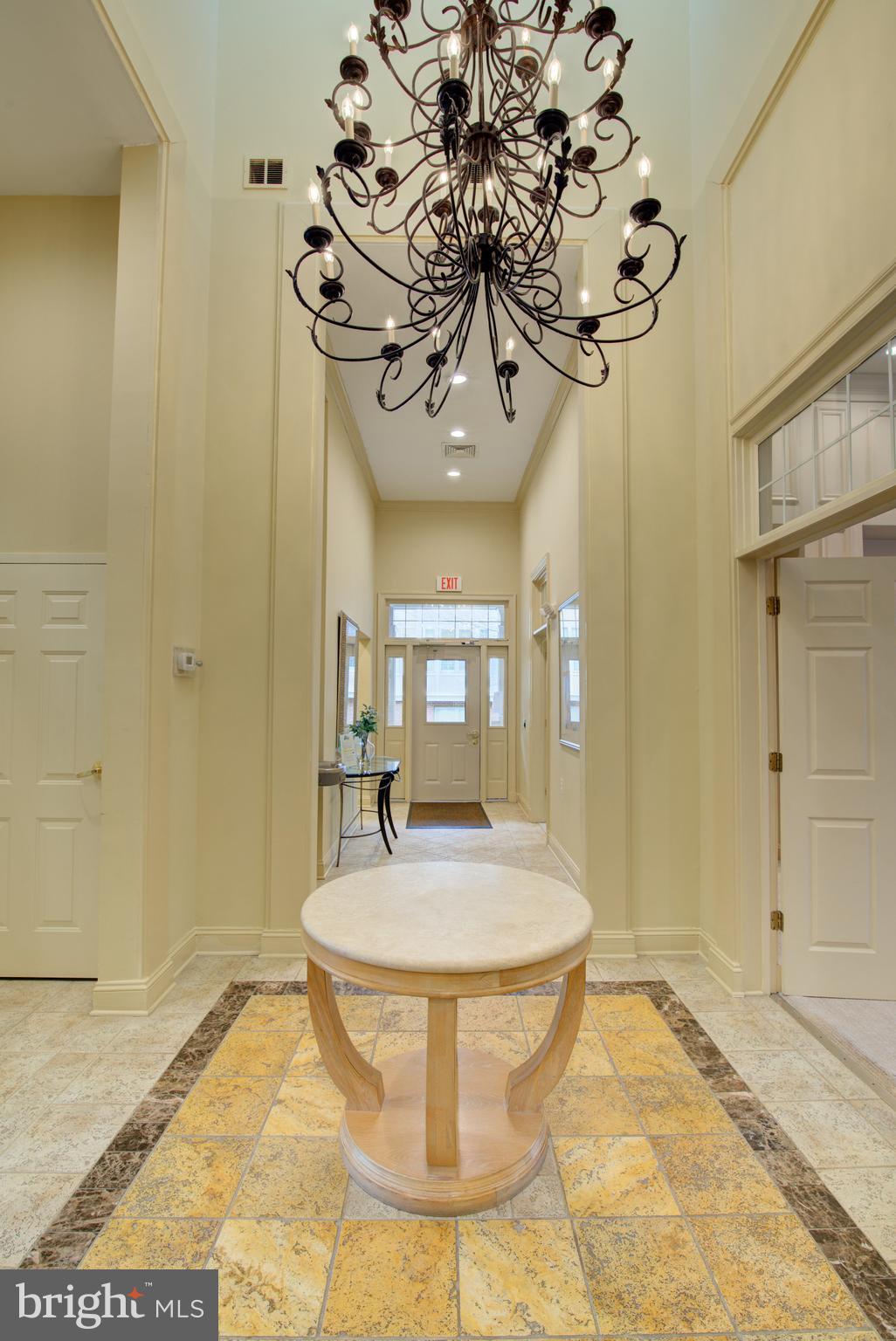 1855 Stratford Park Place, Unit 310 Reston, VA 20190 - Photo 36 of 62 a dining room with chandelier and wooden floor
