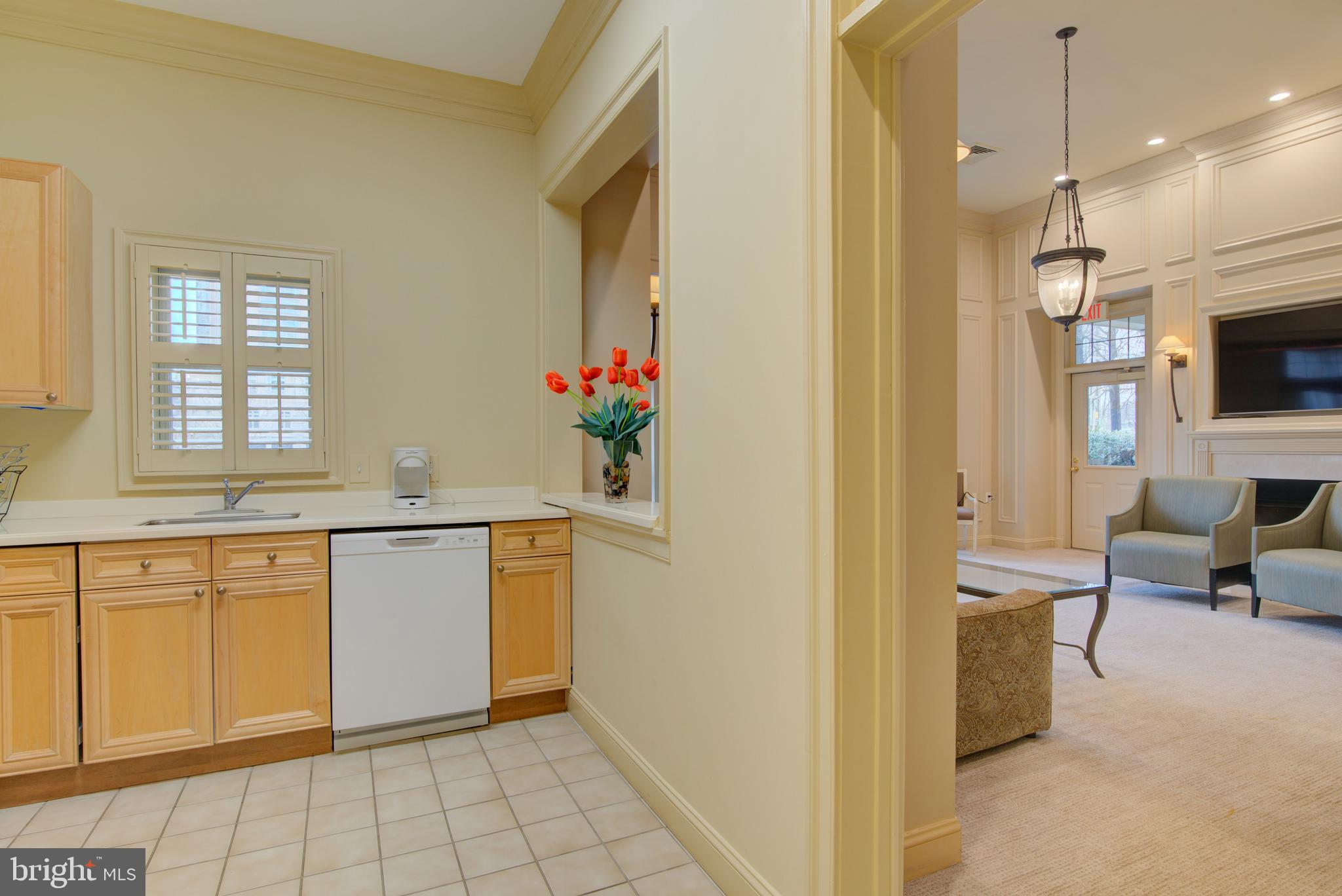1855 Stratford Park Place, Unit 310 Reston, VA 20190 - Photo 37 of 62 a very nice looking kitchen with granite countertop a stove a sink dishwasher and a refrigerator with wooden floor