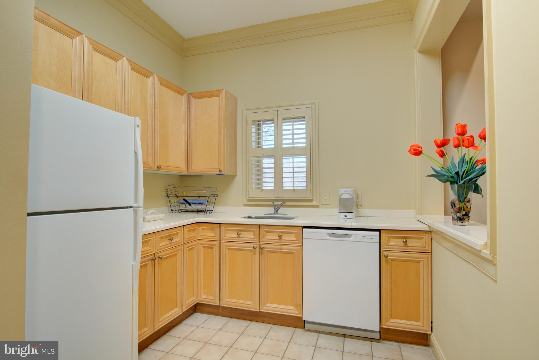1855 Stratford Park Place, Unit 310 Reston, VA 20190 - Photo 38 of 62 a kitchen with a sink a refrigerator and a stove