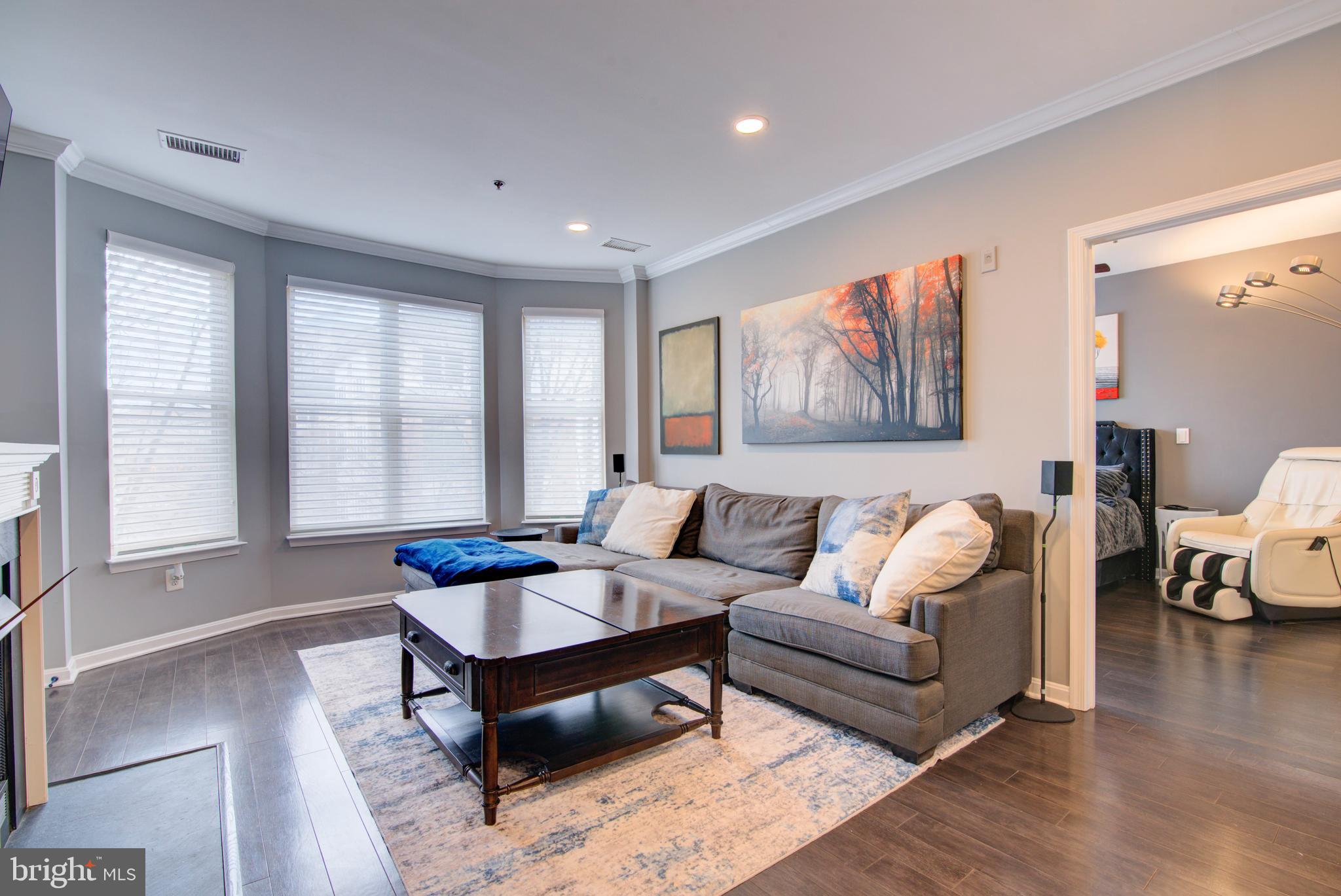 1855 Stratford Park Place, Unit 310 Reston, VA 20190 - Photo 3 of 62 a living room with furniture and a large window