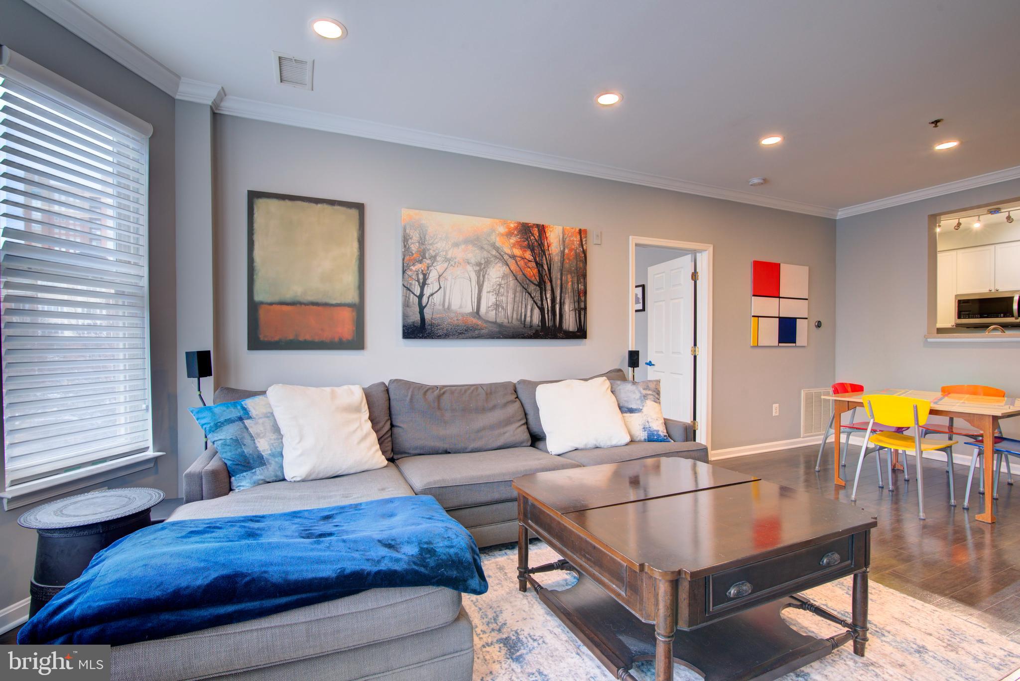 1855 Stratford Park Place, Unit 310 Reston, VA 20190 - Photo 5 of 62 a living room with furniture and wooden floor